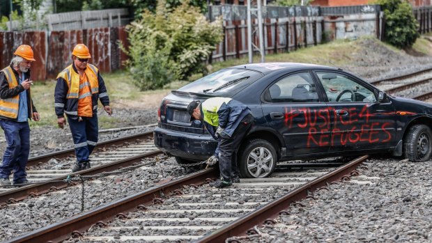 Protesters drove a car onto the railway tracks near Flemington to disrupt the Melbourne Cup Carnival. 