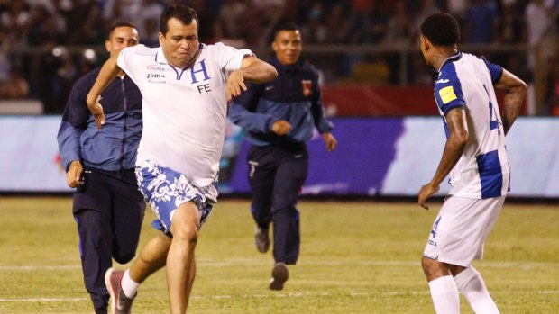 A Honduras fan invades the pitch during the qualifier against Mexico.