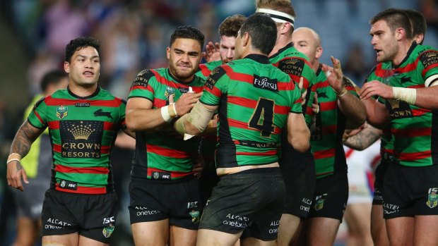 Just like that: Dylan Walker of the Rabbitohs grimaces as he celebrates with his teammates after scoring.