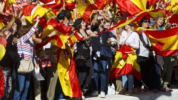 Demonstrators wave Spanish national flags in Colon Square during a protest for Spanish unity in Madrid.