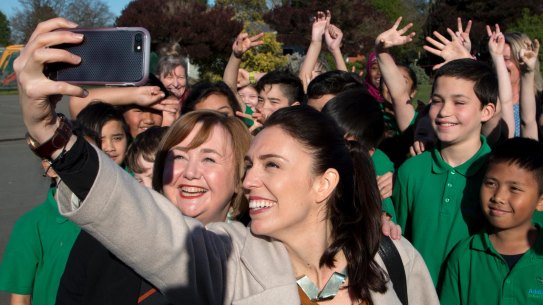 New Zealand Labour Party leader Jacinda Ardern, front right, takes a selfie with school children in Christchurch.