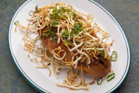 Mapo tofu and noodle bun with fried noodles and spring onion.