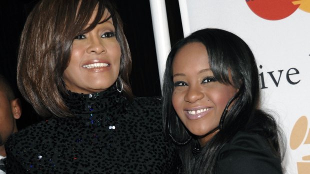 A big burden: Whitney Houston, left, and daughter Bobbi Kristina Brown.