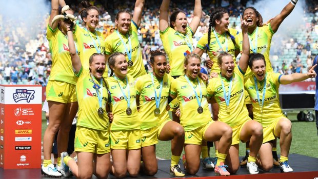 Golden girls: The victorious Australians have their moment on the podium at Allianz Stadium.