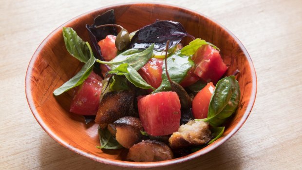 Sourdough croutons are smoked for a juicy tomato panzanella salad.