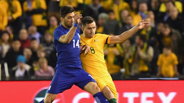 Anastasios Bakasetas of Greece and Australia's Bailey Wright vie for the ball in a friendly at Etihad Stadium in Melbourne on June 7.