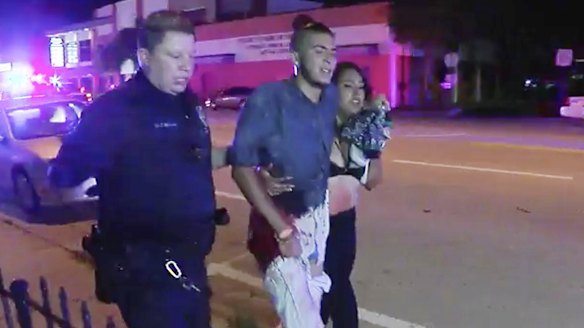 An injured man is escorted out of the Pulse nightclub after the deadly shooting. 
