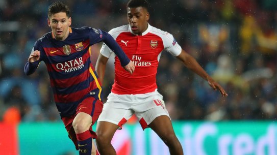 Lionel Messi of Barcelona and Alex Iwobi of Arsenal compete for the ball during the UEFA Champions League, which will be available direct of Foxtel.