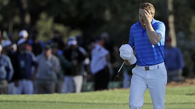 Tough day out: Jordan Spieth walks down the 18th fairway.