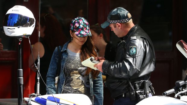 A police officer talks to a pedestrian in the Sydney CBD. 