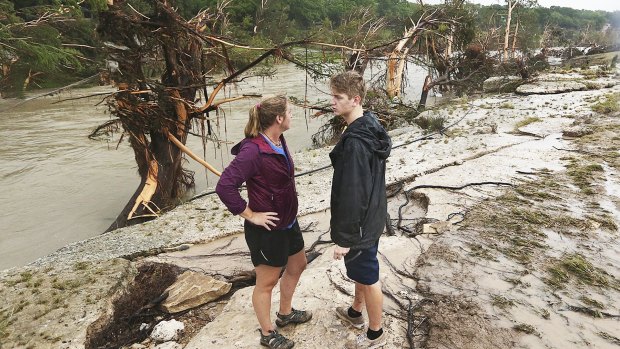 Shelly Guzal and her son Grant stand by the Blanco River where the house that the McCombs were holidaying in once stood. 