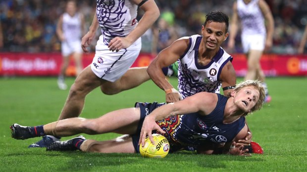 Rory Sloane is tackled by Fremantle's Danyle Pearce.