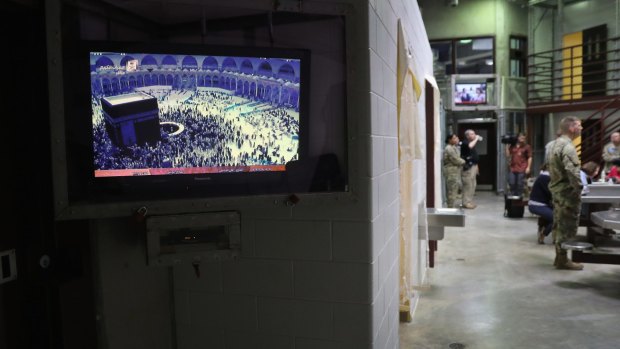 A TV inside Guantanamo Bay plays a program from Mecca.