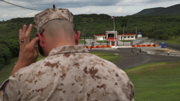 A US Marine stands guard outside the Northeast Gate, the only entrance from the US naval base at Guantanamo into the rest of Cuba.