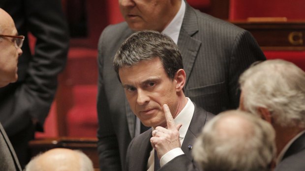 French prime minister Manuel Valls, centre, leaves France's National Assembly, in Paris, in February.