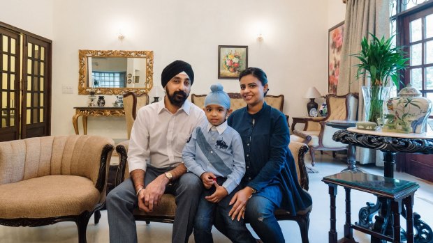 Madhurbain Singh Anand and Guntas Kaur with their son, Mehtab, in their living room in Delhi. 