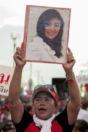 A red-shirted Yingluck supporter at a rally on the outskirts of Bangkok last May, shortly before the Thai military overthrew her government.