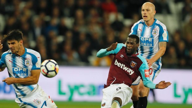 West Ham's Pedro Obiang (right) shoots to score his side's first goal in front of Huddersfield's Aaron Mooy.
