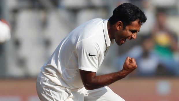 Turning it on: Indian spinner Jayant Yadav celebrates the departure of England's Joe Root.