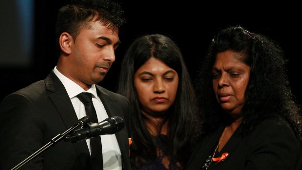 Chinthu Sukumaran (left) speaks during his brother's funeral service.