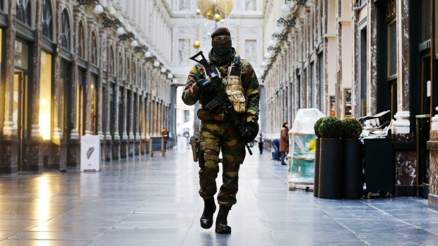 A Belgian soldier patrols a deserted Galeries Royal Saint-Hubert in Brussels.