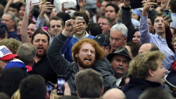 A protester is escorted out of a rally for Republican presidential candidate Donald Trump in Louisville, Kentucky. 