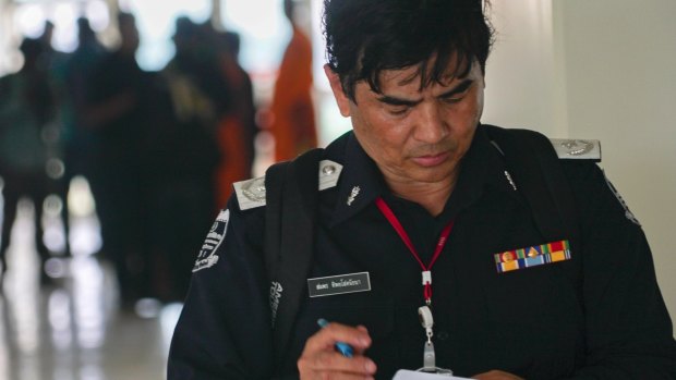 An officer checks his notes inside a medical centre on the Wat Dhammakaya temple compound in Pathum Thani province, Thailand.