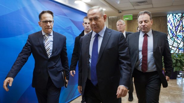 Israeli Prime Minister Benjamin Netanyahu, second right, arrives for a weekly cabinet meeting in Jerusalem on Christmas Day.