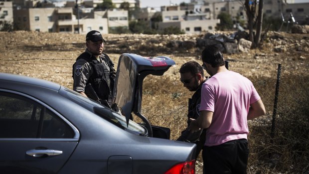 Israeli police and the civilian K-9 Unit search every car that leaves the Palestinian neighbourhood of Jabel Mukaber on Wednesday.