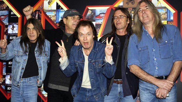 AC/DC's Malcolm Young (left) with Brian Johnson, Angus Young, Phil Rudd and Cliff Williams pose for photographers at the Apollo Hammersmith in London in 2003. 