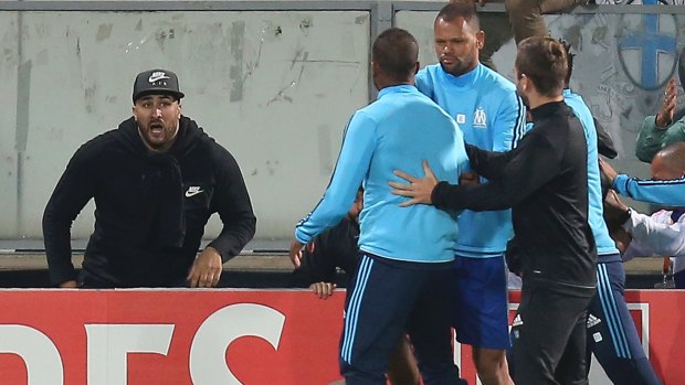 Marseille's Patrice Evra (centre, back to camera) clashed with his own team's supporters.
