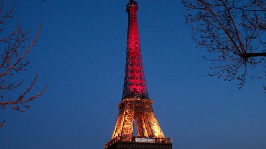 The Eiffel Tower lights up following the Brussels attacks. 
