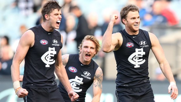 On fire: Carlton’s Lachie Henderson (right) celebrates with Cameron Wood (left) and Dennis Armfield against Port  at the MCG.