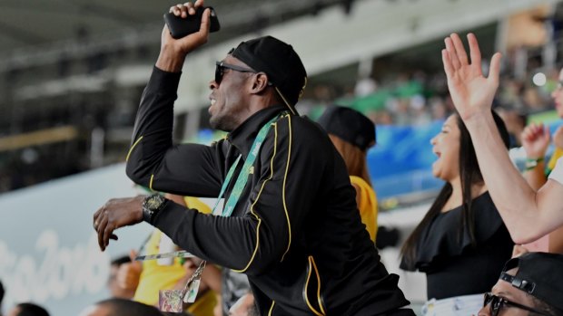 Usain Bolt watches on from the crowd.