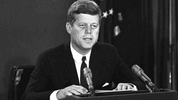 President John F. Kennedy announces a naval blockade of Cuba until Soviet missiles are removed. 