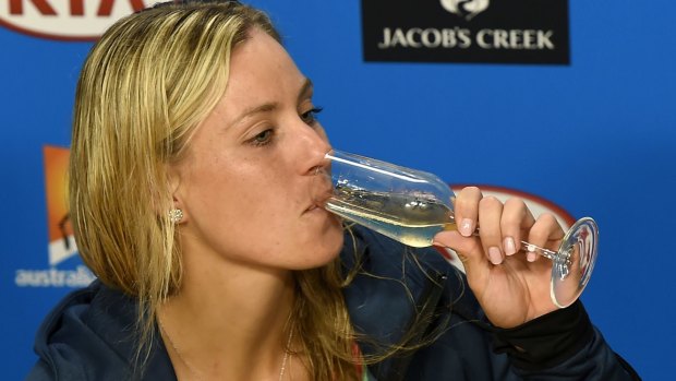Angelique Kerber sips on champagne during the press conference.