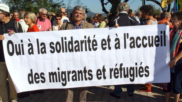 Locals with a 'refugees welcome' banner in the village of Pierrefeu, south-east France.  