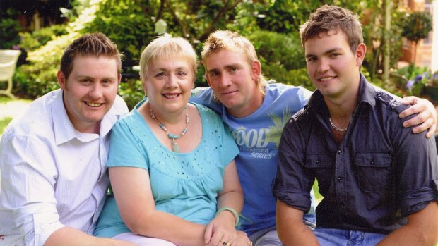 Mitchell Sweeney, 22, died installing foil insulation under the government's rebate program. Left to right: Mitchell's brother Justin, mother Wendy, brother Brendan, and Mitchell.