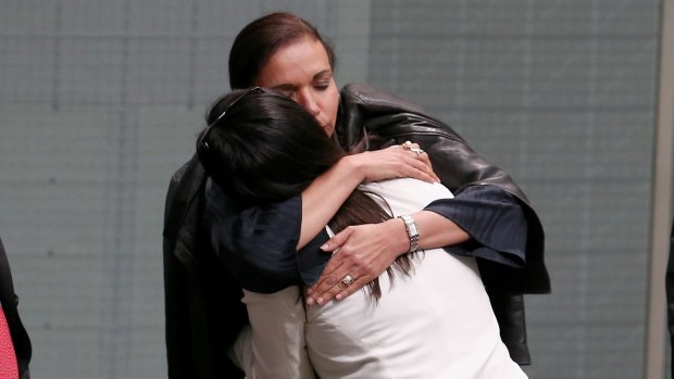 Anne Aly embraces Labor MP Emma Husar after Husar spoke about her experience with family violence.
