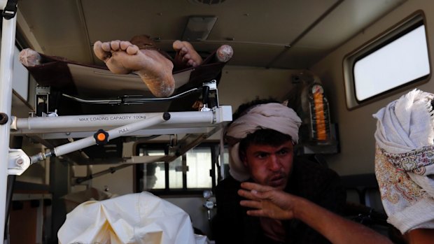 Bodies of victims of a Saudi-led coalition airstrike are loaded into an ambulance.