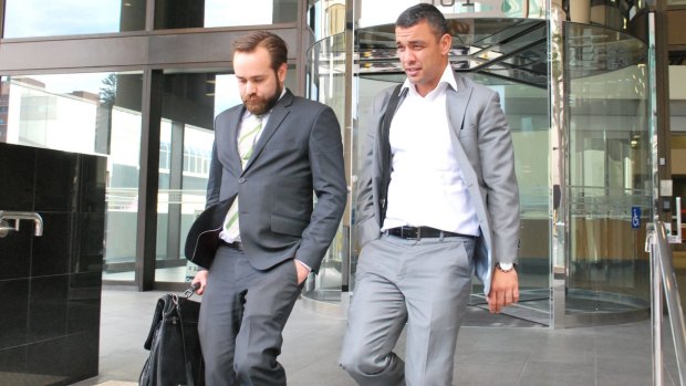 Daniel Kerr and his lawyer leave court after a hearing over alleged VRO breaches was adjourned.