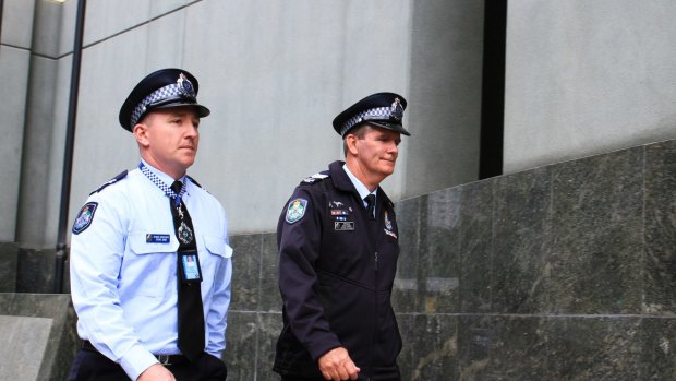 Sergeant Gary Hamrey (right) and Senior Constable Steven Cook walk into Queensland Police Headquarters on Thursday morning.