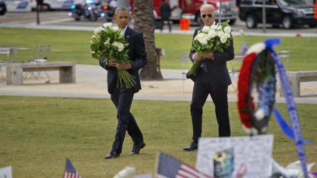 President Barack Obama and Vice President Joe Biden visit a makeshift memorial to the victims of the nightclub shooting.