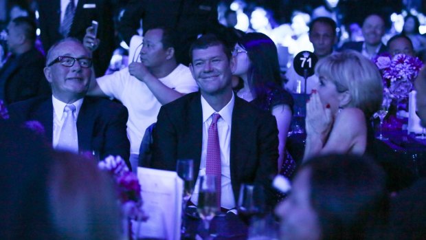 James Packer, sitting next to Julie Bishop, watches on lovingly as Carey performs on stage.