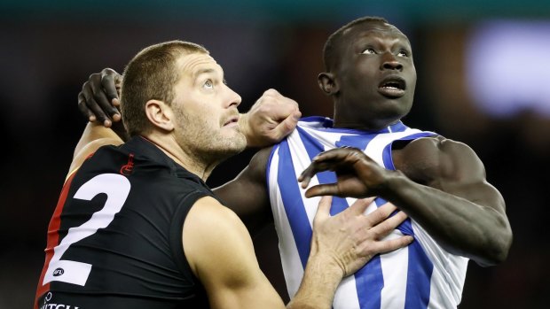 Players such as Tom Bellchambers, left, of the Bombers and Majak Daw of the Kangaroos need to take inspiration from boos to better appreciate cheers when they come.