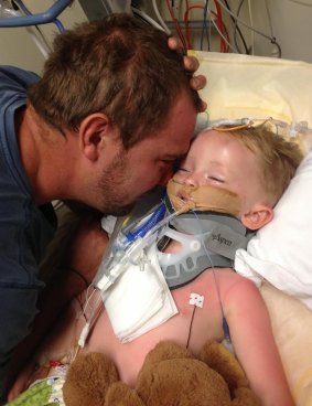 Peter Atkinson spends precious moments with his son Darcy in hospital in 2012.
