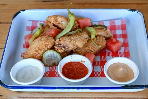 Fried chicken wings with pressed watermelon, chipotle aioli, pickles and tahini yoghurt.
