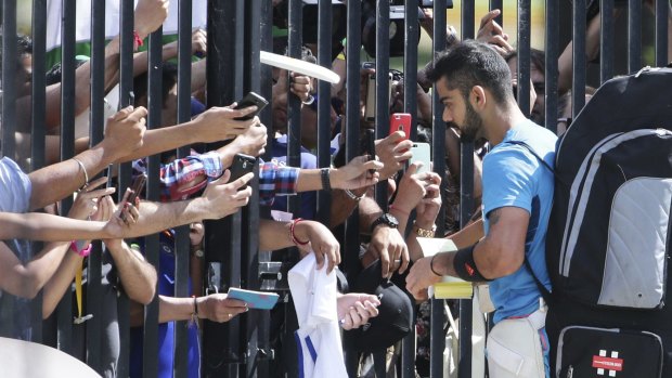 India’s Virat Kohli signs autographs at a nets session at the SCG on Wednesday.