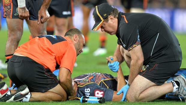 Tough start: Kyle Turner is attended to by medical staff after being tackled by Paul Gallen on Friday night.