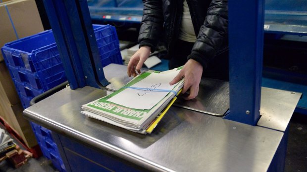 A worker prepares the new edition of <i>Charlie Hebdo</i> for delivery in Marne-la-Vallee, France.  Five million copies of the controversial magazine have been printed in the wake of last week's terrorist attacks.